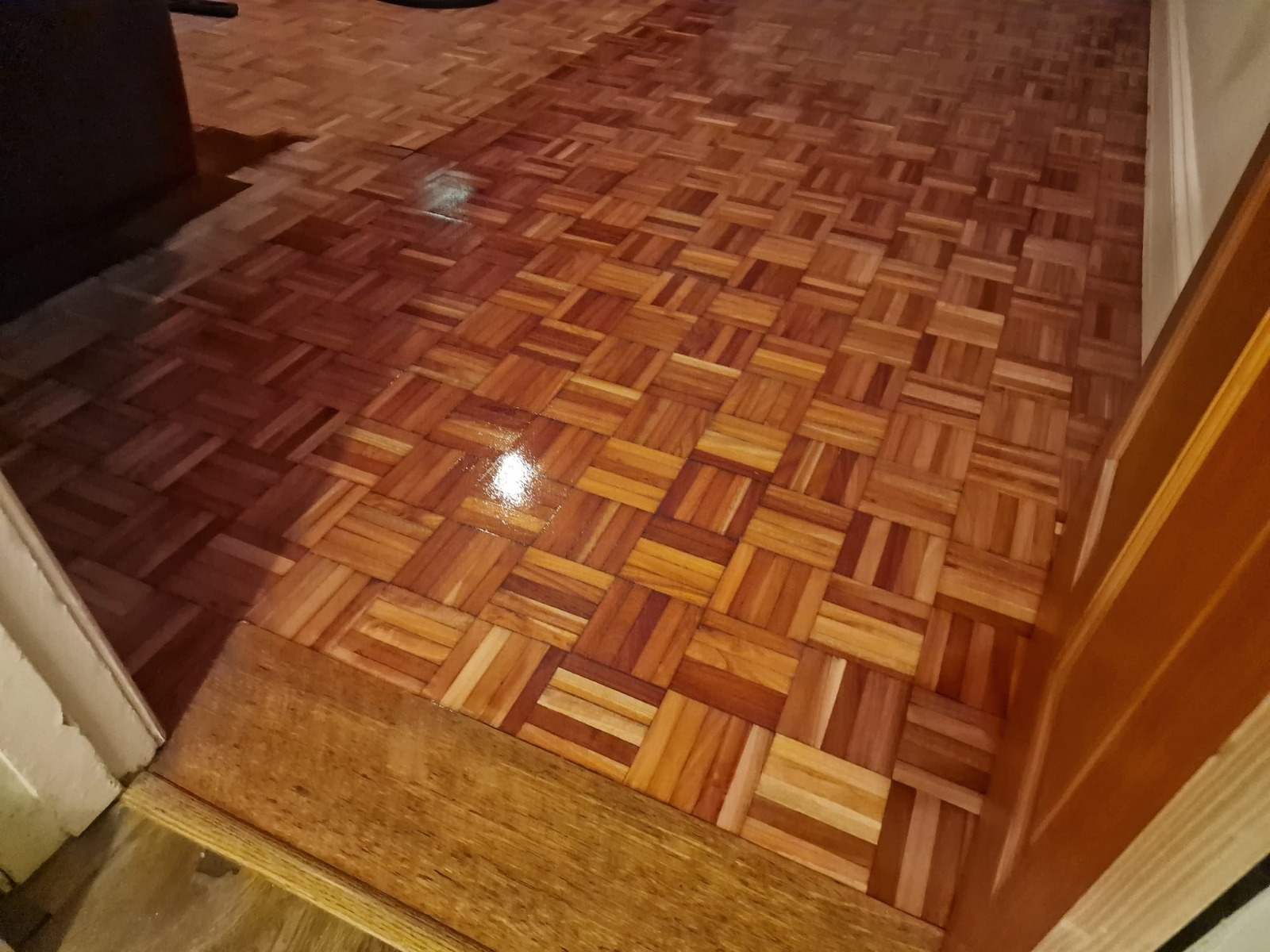 Wood Floor Sanding in Eltham showing a freshly finished oak mosaic parquet hallway floor with a glossy sheen.
