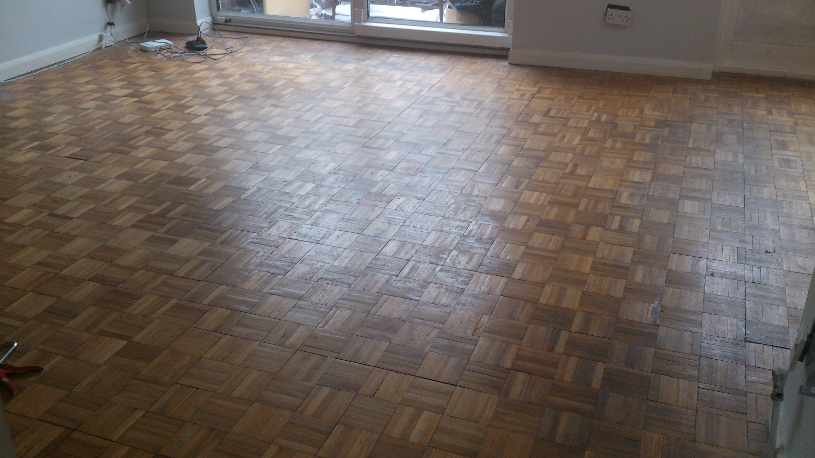 Wood Floor Sanding in Eltham on a worn oak mosaic parquet living room floor before restoration.